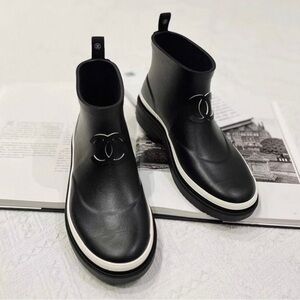 CHANEL Black Ankle Boots with White Accents